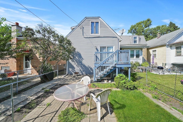 rear view of property with a patio and a lawn