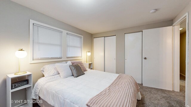 carpeted bedroom featuring multiple closets