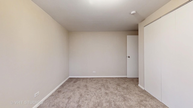 unfurnished room with light carpet