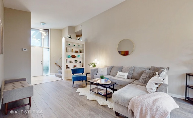 living room featuring light wood-type flooring and floor to ceiling windows