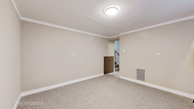 empty room with ornamental molding and carpet