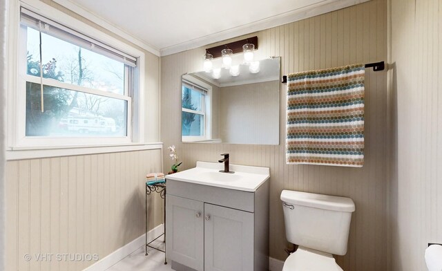 bathroom with ornamental molding, vanity, and toilet