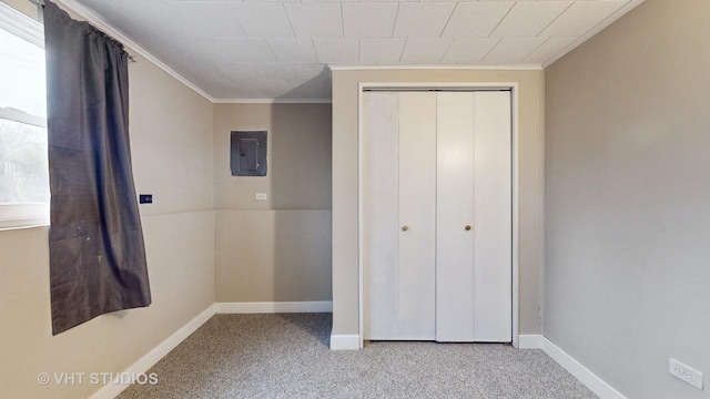 unfurnished bedroom featuring ornamental molding, light carpet, electric panel, and a closet