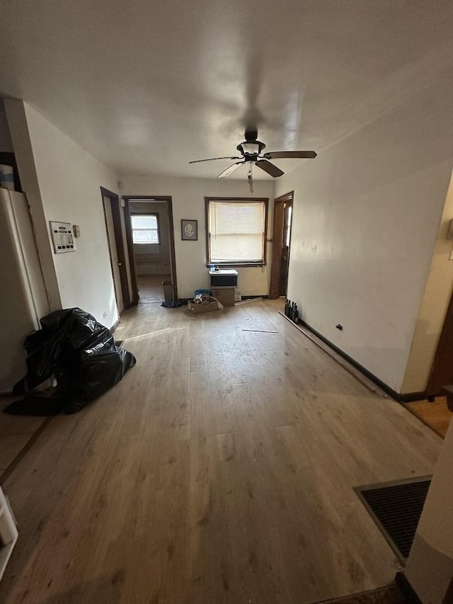 unfurnished living room with light hardwood / wood-style floors and ceiling fan