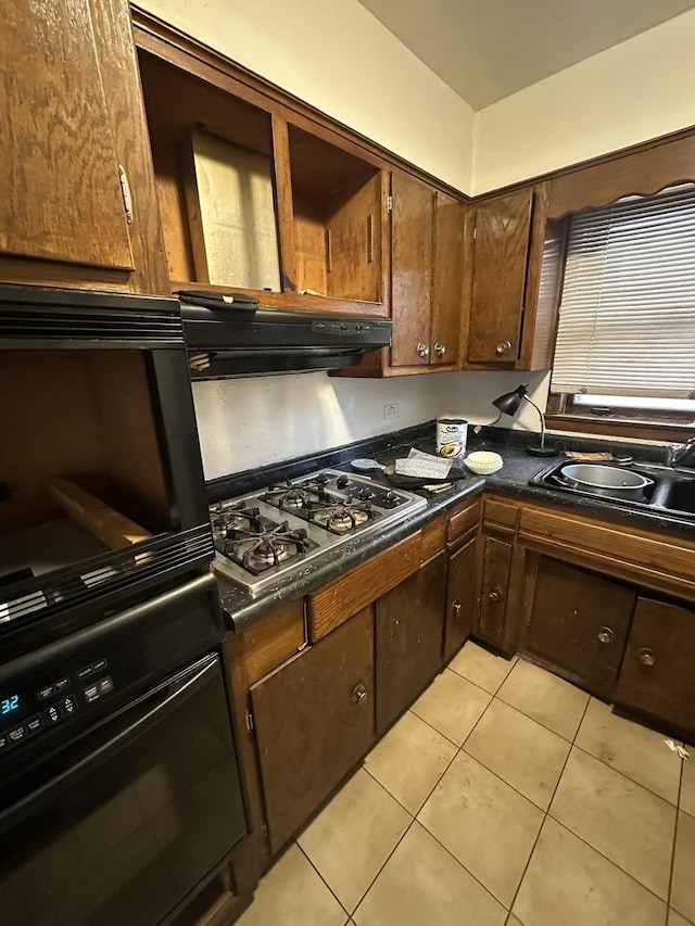 kitchen featuring wall oven, light tile patterned floors, gas cooktop, and sink