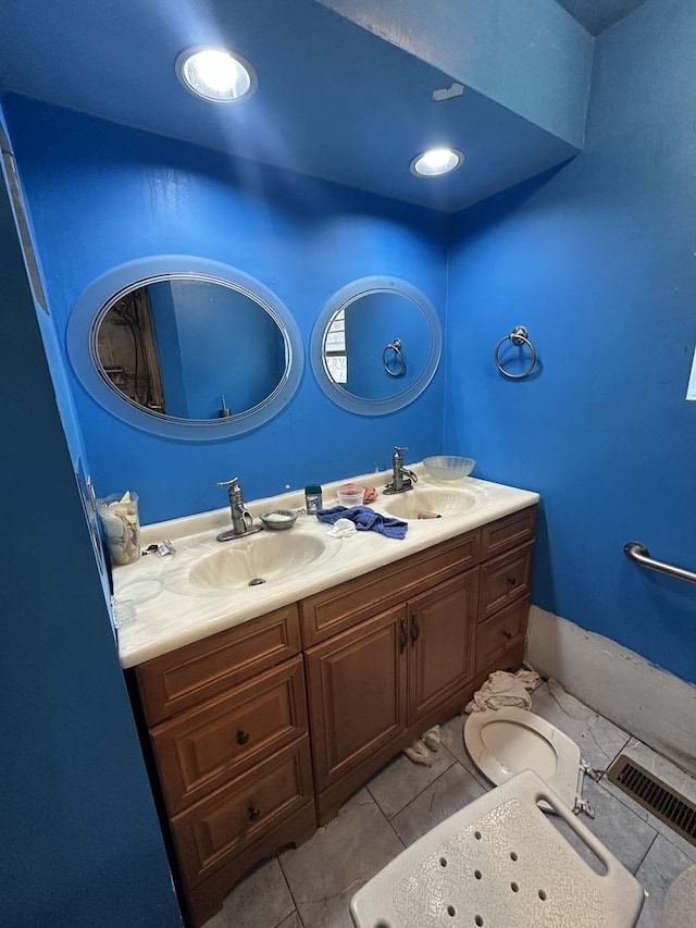 bathroom with tile patterned flooring and vanity