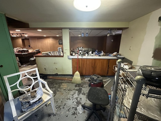 miscellaneous room with concrete floors and wooden walls