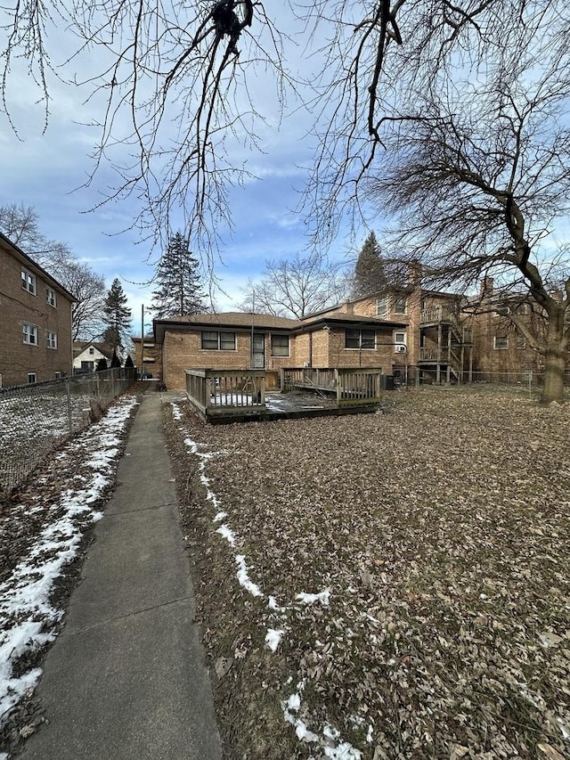 view of snow covered rear of property