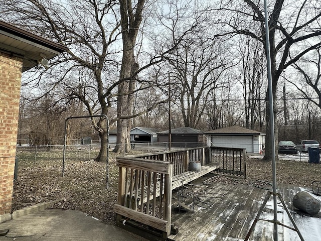 deck featuring a garage and an outbuilding