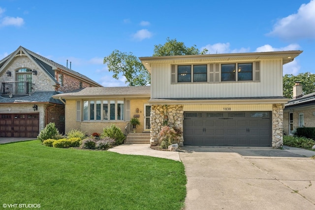 view of front of home with a front yard and a garage