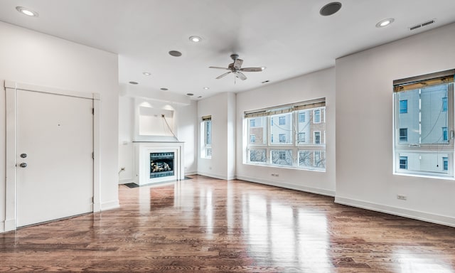 unfurnished living room with ceiling fan and hardwood / wood-style floors