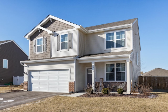 view of front of house featuring a front yard and a garage