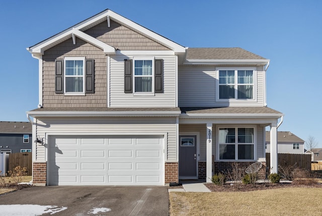 craftsman-style home with a front yard and a garage