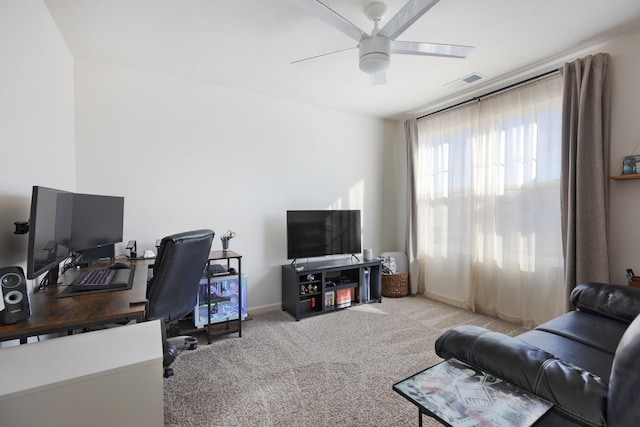 carpeted office featuring ceiling fan