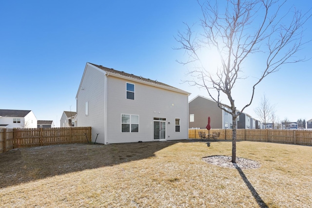 rear view of property featuring a lawn