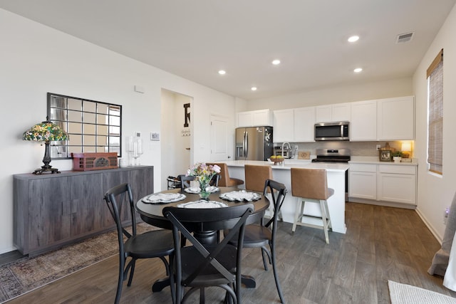 dining space with dark wood-type flooring