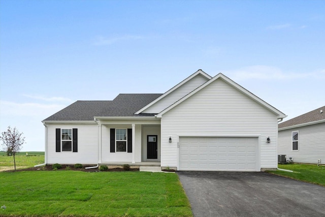 view of front of home featuring central AC unit, a garage, and a front yard