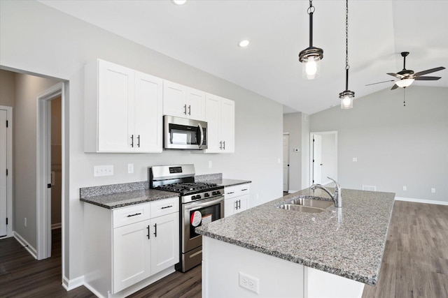 kitchen featuring pendant lighting, sink, white cabinetry, and appliances with stainless steel finishes