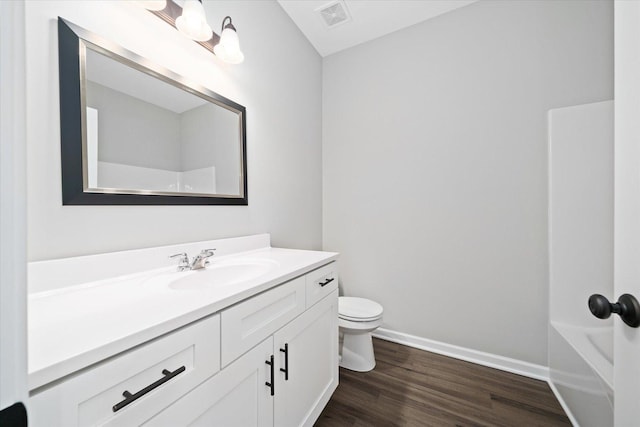 full bathroom featuring vanity, toilet, tub / shower combination, and hardwood / wood-style floors