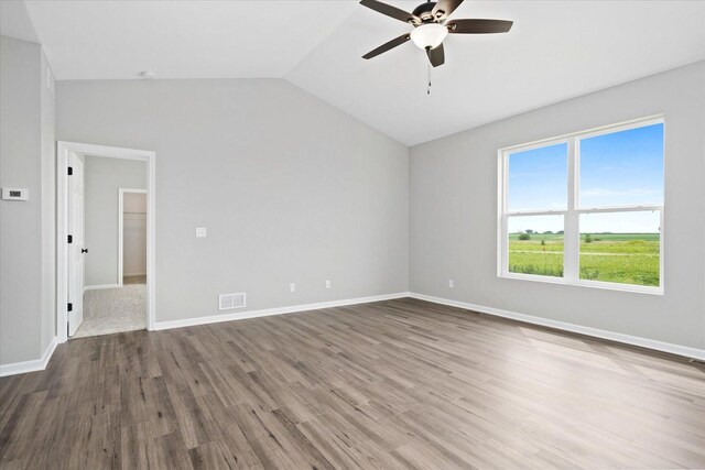 unfurnished room with hardwood / wood-style flooring, ceiling fan, and lofted ceiling