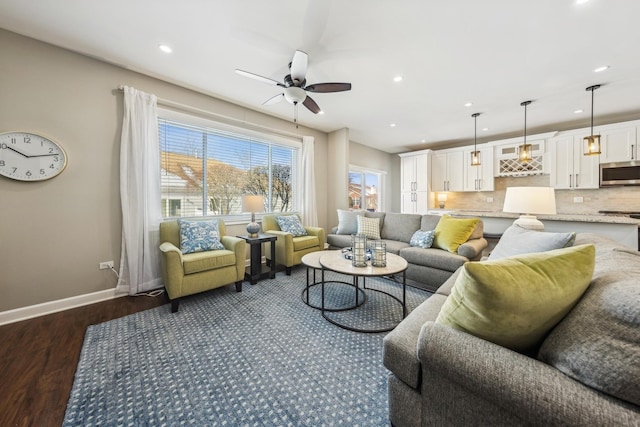 living room featuring ceiling fan and dark hardwood / wood-style flooring