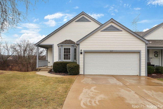 view of front of home featuring a garage and a front lawn