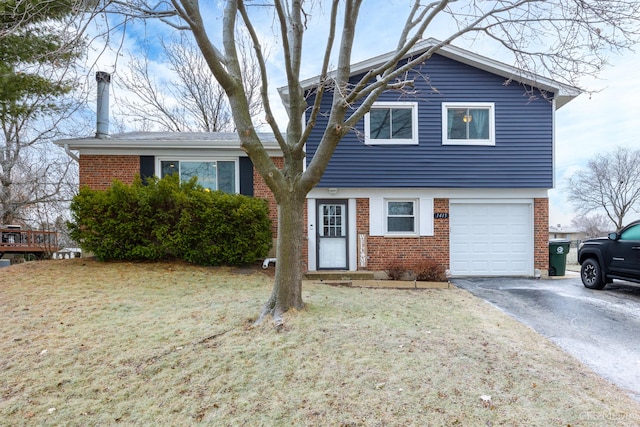 view of front of property with a front yard and a garage