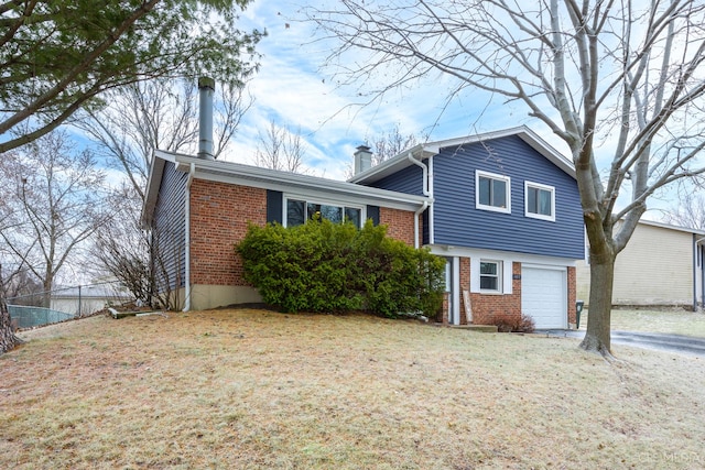 tri-level home with a front lawn and a garage