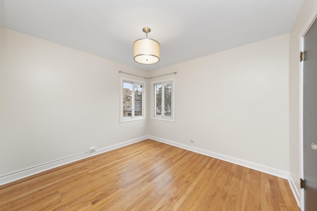 spare room with light hardwood / wood-style flooring