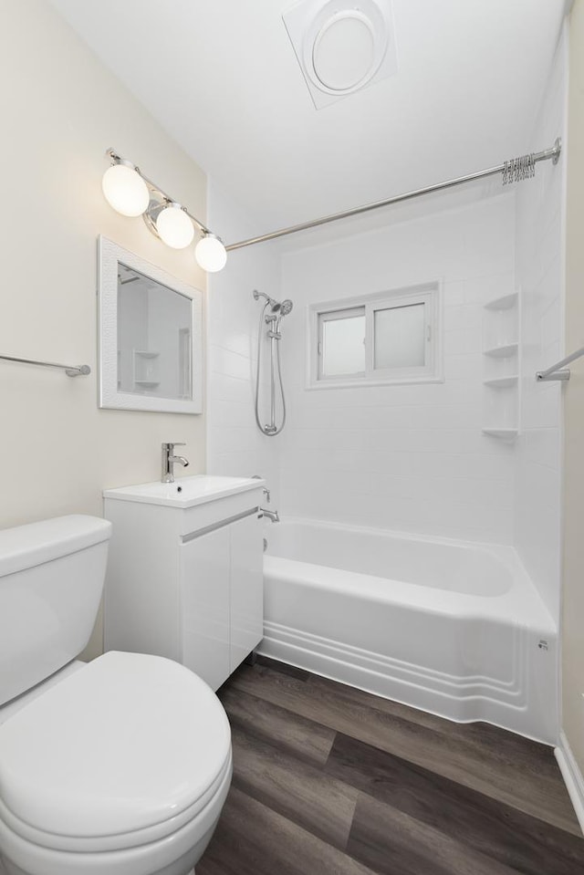 full bathroom featuring toilet, vanity, shower / tub combination, and hardwood / wood-style floors