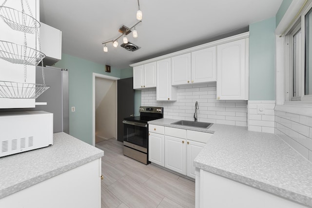 kitchen with white cabinetry, stainless steel electric range, and sink