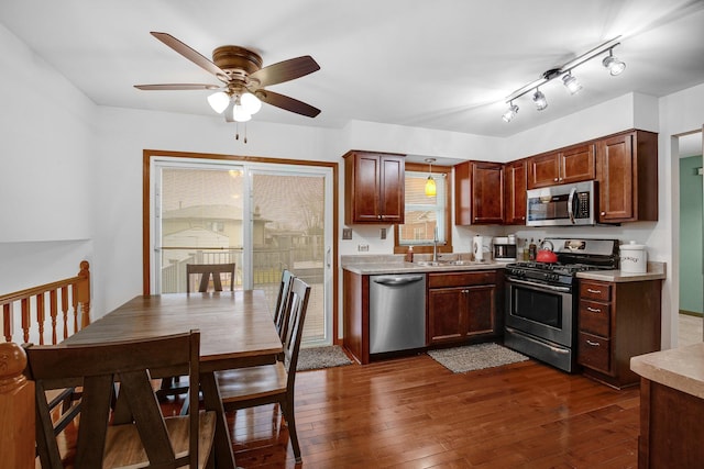 kitchen featuring sink, dark wood-type flooring, ceiling fan, and appliances with stainless steel finishes