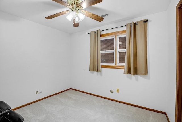 unfurnished room with ceiling fan and carpet