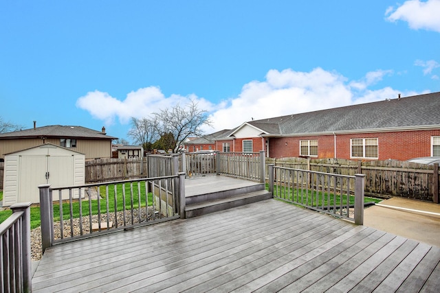 wooden deck with a shed and a lawn