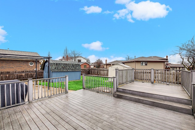 deck with a yard and a storage unit