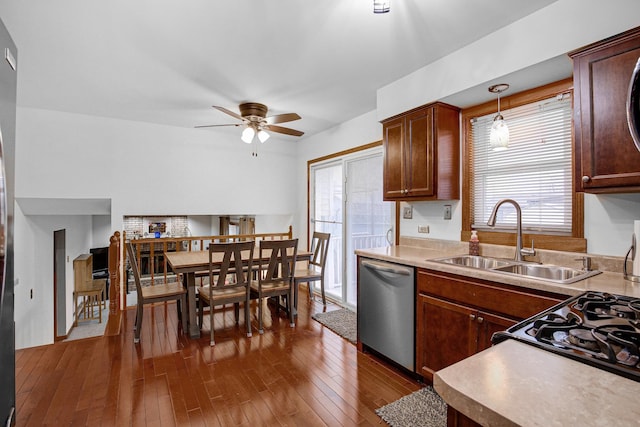 kitchen featuring sink, hanging light fixtures, plenty of natural light, dark hardwood / wood-style floors, and stainless steel dishwasher