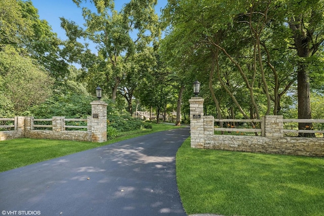 exterior space with a lawn and fence