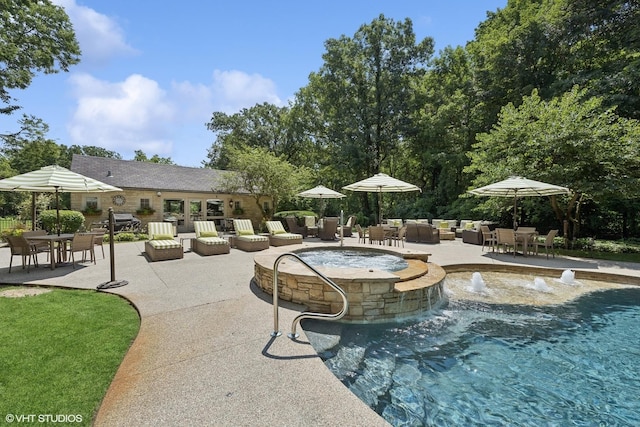 view of pool with outdoor dining space, a patio area, an outdoor living space with a fire pit, and a pool with connected hot tub