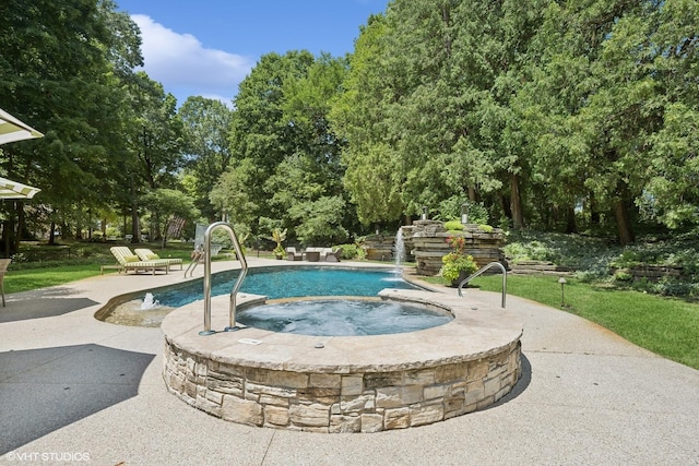 view of swimming pool featuring a patio, pool water feature, and an in ground hot tub