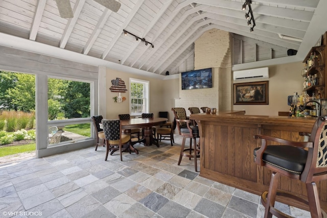 bar featuring stone tile floors, wooden ceiling, a wall mounted air conditioner, a bar, and high vaulted ceiling