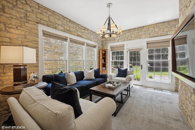 living room featuring carpet floors, a chandelier, and plenty of natural light