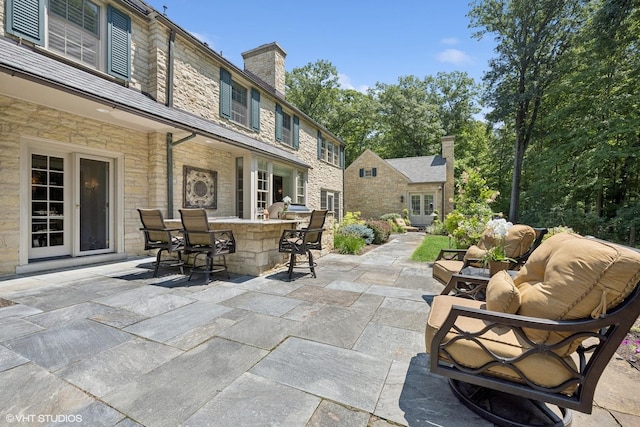 view of patio with outdoor dry bar, french doors, and outdoor lounge area