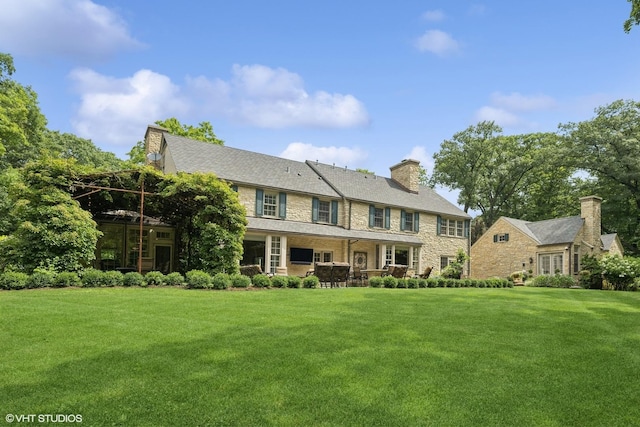 view of front of home featuring a chimney and a front yard