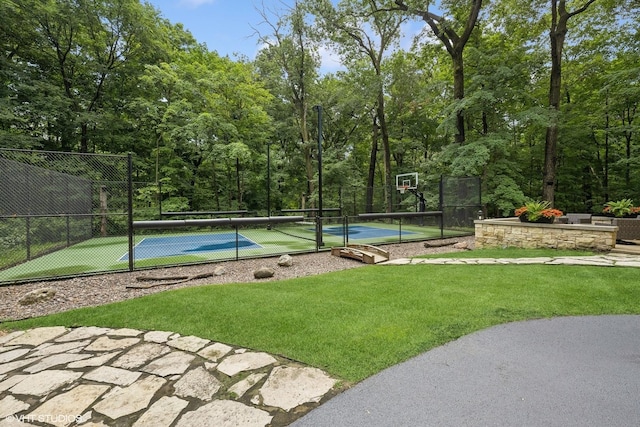 view of basketball court with tennis court and a lawn