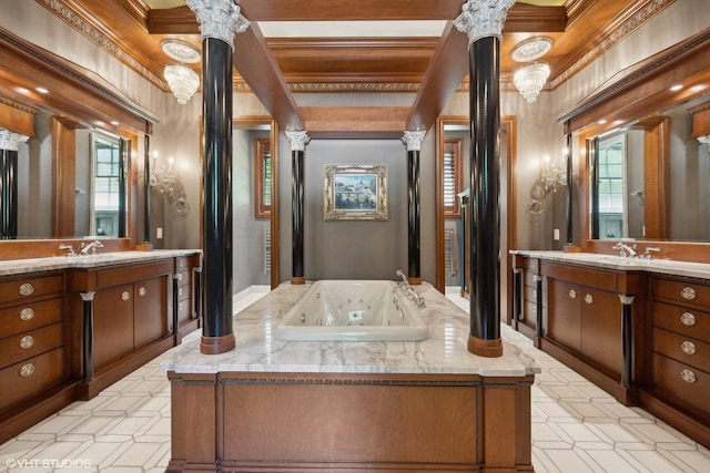 full bath with two vanities, decorative columns, a tub with jets, and tile patterned floors