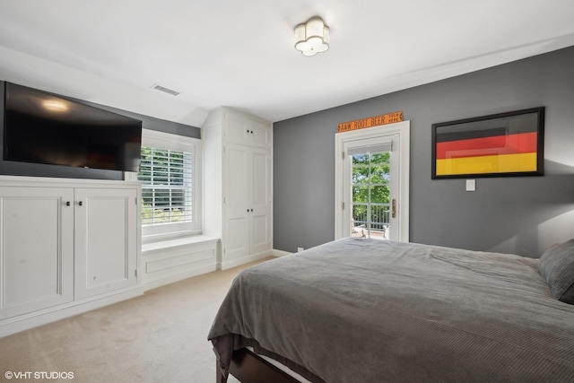 bedroom featuring access to exterior, light colored carpet, and visible vents