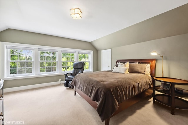 bedroom with lofted ceiling, multiple windows, and carpet floors