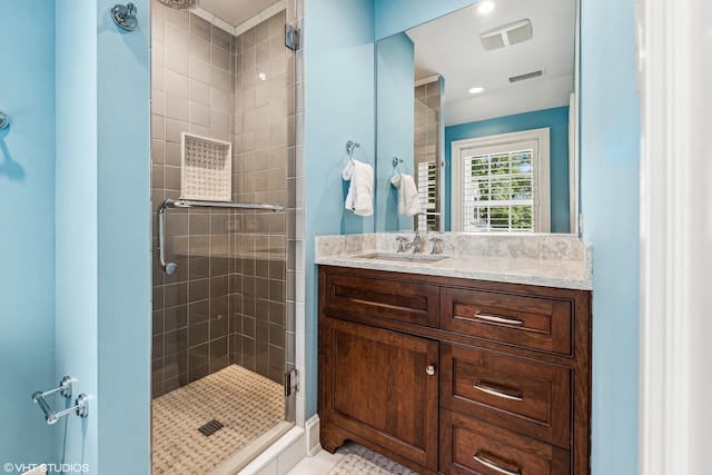 bathroom featuring an enclosed shower, vanity, and tile patterned floors