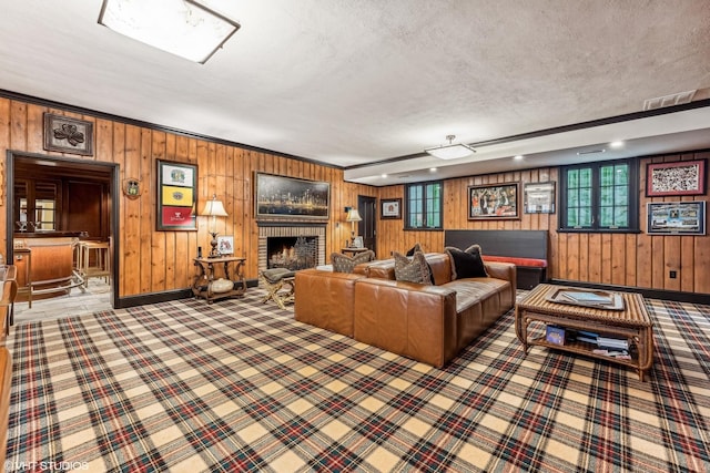 carpeted living room with a textured ceiling, a fireplace, and baseboards