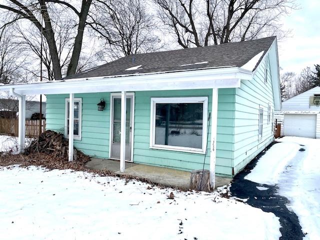 view of front of property with an outbuilding, covered porch, and a garage